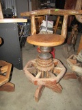 PRIMITIVE MADE BAR STOOL WITH WOODEN WAGON HUB BASES APPROX 3 1/2 FEET TALL