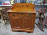 ANTIQUE OAK WASH STAND WITH CARVED BACK SPLASH AND FRONT ONE DRAWER TWO DRA