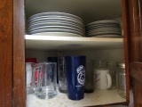 CONTENTS OF TWO CABINETS INCLUDING COFFEE MUGS GLASSES PLATES AND MORE
