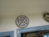 COLLECTION OF PLATES ON WALL INCLUDING MEXICAN POTTERY ROSE MEDALLION GAME