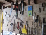 TOOLS ON PEG BOARD INCLUDING PIPE WRENCHES OPEN END WRENCHES TRIMMERS SAWS