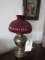 ANTIQUE BRASS BRADLEY AND HUBBARD CONVERTED OIL LAMP WITH RED SHADE