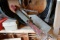 SHELF LOT INCLUDING ROAD FLARES ANTIQUE HAND PLANTER HONEY BEE EQUIPMENT AN