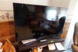 SAMSUNG FLAT SCREEN TV APPROX 48 INCH WITH ENTERTAINMENT CENTER AND DECORAT