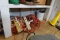 BOTTOM SHELF OF SHED INCLUDING EXTENSION CORDS OLD BOTTLES TOOLS LANTERN AN
