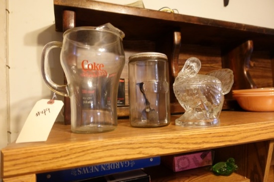 COUNTER LOT INCLUDING COKE PITCHER ANTIQUE COFFEE CANISTER AND TURKEY CANDY