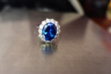 STERLING RING WITH 14 CZ AND LARGE BLUE STONE W .25 T OZ