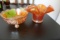 PAIR OF ORANGE CARNIVAL GLASS PCS INCLUDING FLUTED BOWEL AND FOOTED BUTTERF