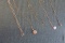 5 GOLD NECKLACES INCLUDING ANTIQUE LOCKET AND DAUGHTER OF AMERICA