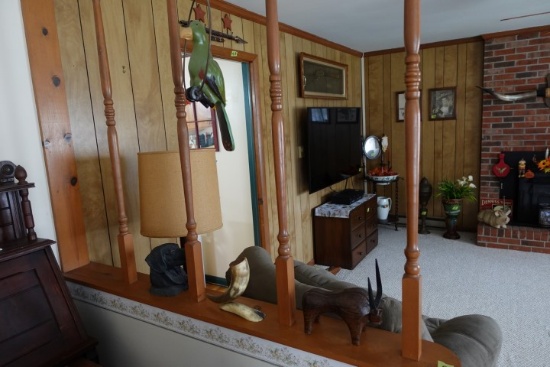 DECORATVES ON LEDGE INCLUDING BLACK LAB BUST HANGING PARROT BULL AND HORNS
