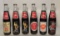 (6) Collectible Coca Cola Bottles:  (1) 1984