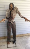 6 foot tall lurching zombie Halloween figurine.