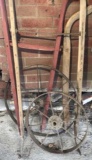 Old push plow handles and wheels