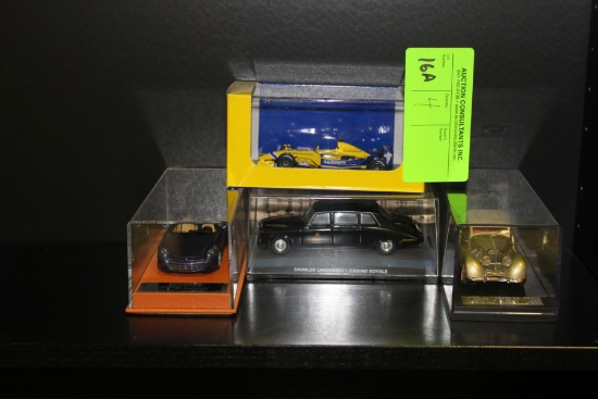 Four die cast toys, Ferrari, Mercedes 500, Daimler Limousine Casino Royale,