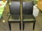 Two leather and brass studded dining chairs