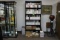 Bookshelf with travel and auction catalogs from Antiquorum, pocket watches,