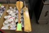 Two menus on a paddle and a cricket bat