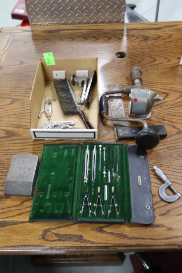 Vintage tools including hand drill, pencil sharpener, stapler, and drafting kit