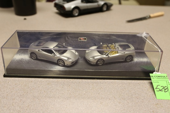 Hot Wheels display featuring diecast model cars including Ferraris
