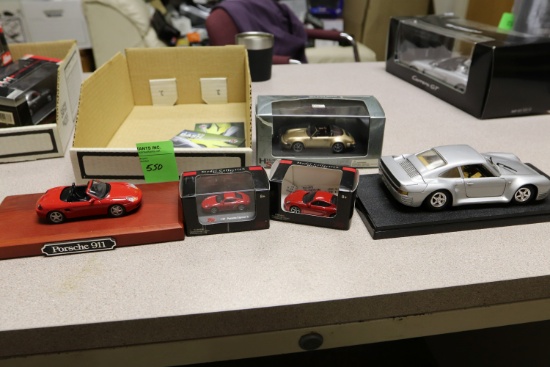Diecast cars including 1:18 Porsche, two 1:87 High Speed Porsches, one 1:43 Porsche