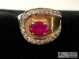 Size 7 Gold ring with ruby and clear stones not tested stamped 325