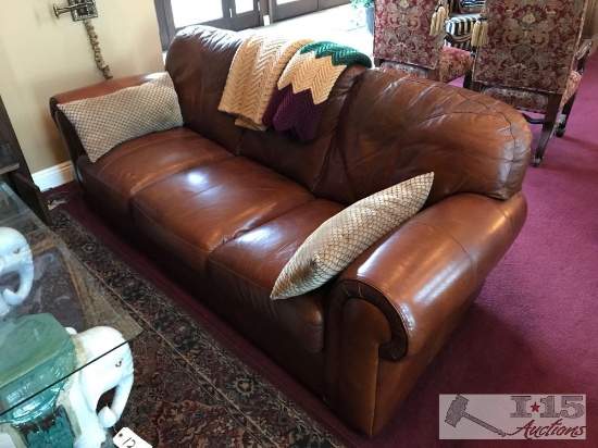 Leather sofa with 2 afghan?s and 2 pillows