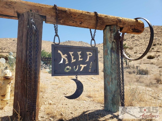Metal Keep Out! Sign with Chains and Partial Wagon Wheel