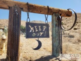 Metal Keep Out! Sign with Chains and Partial Wagon Wheel