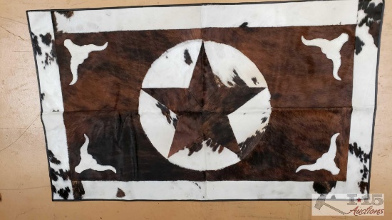 Cowhide rug with longhorn and star design.