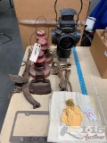 Antique trail signal, lanterns, trap, hane, sack with tags, and volvo license plate frame