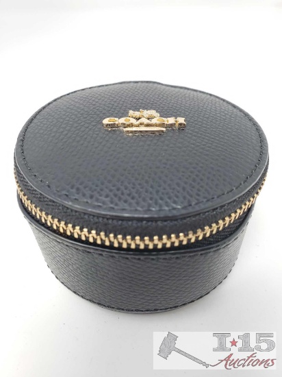 Black round leather zippered Coach jewelry bag