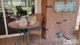 Patio Table, Wicker Chair, Watering Can, and Table Decor