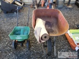Wheelbarrow, Roll Of Paper, And Scotts Spreader