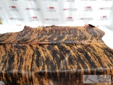 Large Brazilian Brindle hair on cowhide rug. Measures approximately 38-46 square feet.