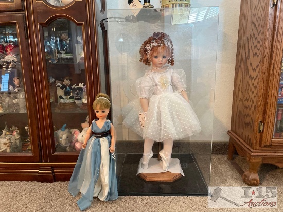2 Dolls on Stands and one in a Display Case