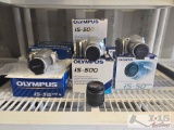 (10) Olympus Cameras and (1) Canon 58mm Camera Lense