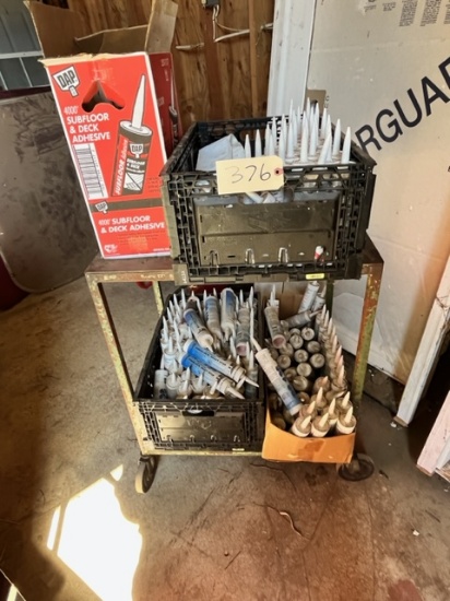METAL ROLLING CART WITH (4) BOXES OF CAULKING AND ADHESIVE