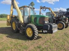 John Deere row-crop tractor, 7020 or 7030 series equipped with a cab and front weight