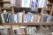 SHELF OF BOOKS AND TWO UPPER CUBBY HOLES