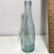 Blue Tint Bottle with Embossed Guy on Bottom