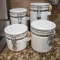Set of 4 White Ceramic Canisters with Scoops