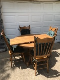 Round Dining Table with Four Chairs and a Leaf