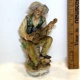Porcelain Old Man on Tree Stump Playing Banjo Figurine