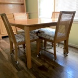 Wooden Dining Table with 4 Cane Back Chairs with Upholstered Seats on Casters