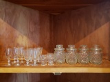 Shelf Lot of Glass Barware and Apothecary Style Jars