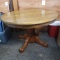 Round Oak Dining Table with 4 Leg Pedestal Base and Paw Feet