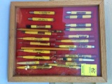 Collection of pens and pencils in display case