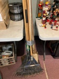 Bundle of garden tools call shovel post hole digger leaf rakes