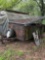 Old pop-up camper trailer with car parts hubcaps fenders