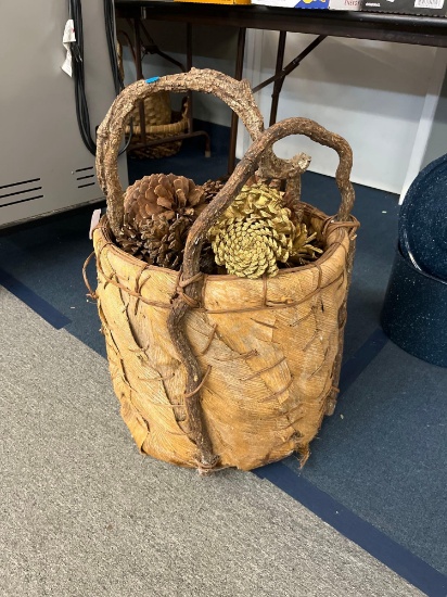 Large basket filled with pine cones approx 18 x 27 inches tall to top of handle and blue printed